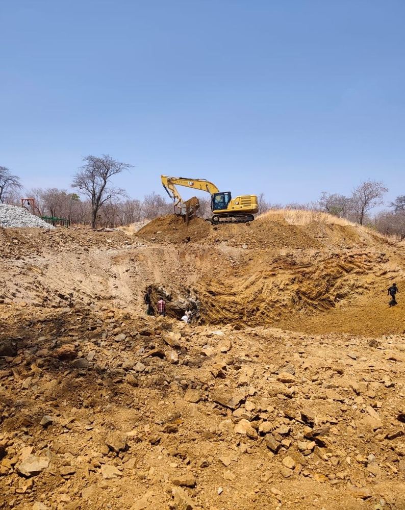 Excavator rehabilitating existing shafts, Chunya